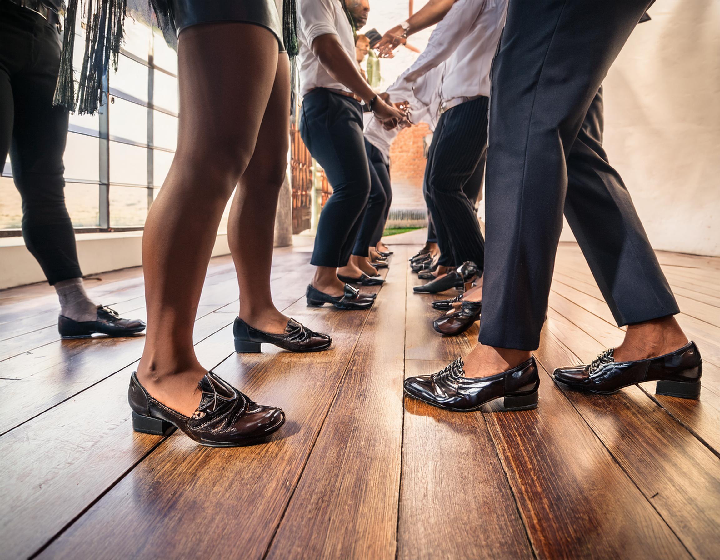 Adult tap shoes striking the floor during a Tap-in-Line session